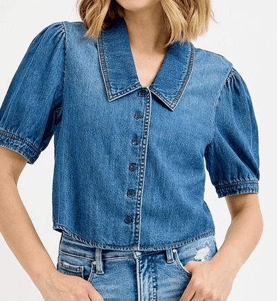 Denim shirt with puff sleeves worn by a person on a white background