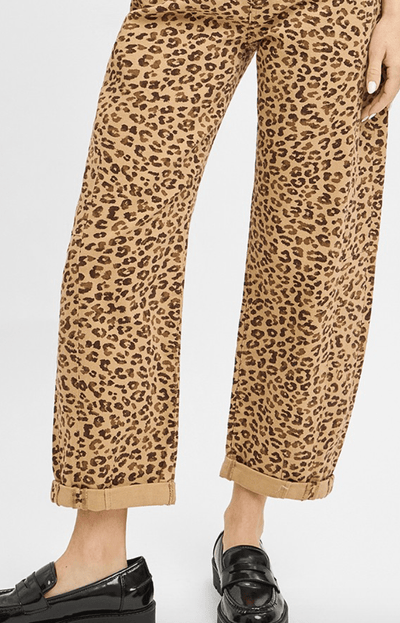 Leopard print pants worn by a person on a white background